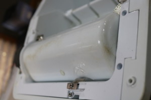 Bottom of water tray, showing mold/dirt accumulation.
